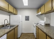 Thumbnail 11 of 19 - a kitchen with a white refrigerator next to a stove top oven at Willows Court Apartment Homes, Seattle, Washington 98125