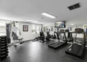 Thumbnail 7 of 19 - a gym with cardio equipment and a flat screen tv at Willows Court Apartment Homes, Washington, 98125