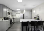 Thumbnail 18 of 19 - a kitchen with gray cabinets and a white counter top at Willows Court Apartment Homes, Seattle, Washington 98125
