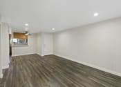 Thumbnail 17 of 18 - Oversized Living Room with Hardwood Floors and White Walls at Park 210 Apartment Homes, Edmonds, 98026