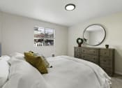 Thumbnail 11 of 25 - a bedroom with a large bed and a dresser with a mirror