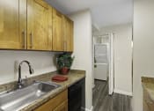 Thumbnail 22 of 25 - a kitchen with a sink and a washer and dryer