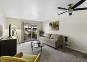 Thumbnail 15 of 25 - a living room with a couch coffee table and a ceiling fan