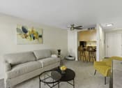 Thumbnail 20 of 25 - a living room with a couch a table and a ceiling fan