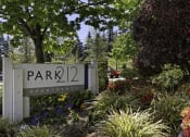 Thumbnail 3 of 25 - a park with a sign that says park 22 apartments