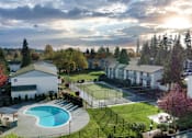 Thumbnail 5 of 23 - an aerial view of a community with a pool and tennis court at Pinewood Square Apartment Homes, Lynnwood, WA, 98036
