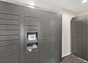 Thumbnail 10 of 23 - a row of package receiving lockers in the resident package room at Pinewood Square Apartment Homes, Lynnwood