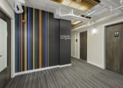 Thumbnail 9 of 27 - Corridor with Wall Art with a white lettering on it at Sir Gallahad Apartment Homes, Bellevue, Washington 98004