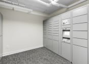 Thumbnail 11 of 27 - Resident Parcel Receiving Room with Package Lockers and Carpeted Floor at Sir Gallahad Apartment Homes, Washington