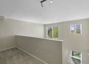 Thumbnail 19 of 27 - Loft-Style Bedroom with Wall to Wall Carpeting, and Multiple Window Views at Sir Gallahad Apartment Homes, Bellevue, 98004