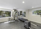 Thumbnail 5 of 27 - Fitness Facilities with a Treadmill, Weights, and Oversized Windows for an Abundance of Light  at Sir Gallahad Apartment Homes, Bellevue, WA