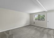 Thumbnail 11 of 30 - an empty bedroom with a window and a door at Swiss Gables Apartment Homes, Kent, 98032