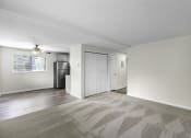 Thumbnail 14 of 30 - a living area with carpeting and a ceiling fan at Swiss Gables Apartment Homes, Kent, 98032