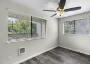 Thumbnail 18 of 30 - Living Area with two windows and a ceiling fan at Swiss Gables Apartment Homes, Kent, Washington 98032