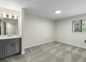 Thumbnail 16 of 30 - a bedroom with a large window and private vanity at Swiss Gables Apartment Homes, Kent, WA