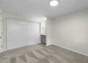 Thumbnail 21 of 30 - a bedroom with white walls and carpet at Swiss Gables Apartment Homes, WA 98032