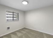 Thumbnail 26 of 30 - a bedroom with white walls and a window at Swiss Gables Apartment Homes, Kent