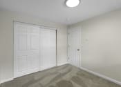 Thumbnail 17 of 30 - a bedroom with two closet doors and a carpeted floor at Swiss Gables Apartment Homes, Kent, 98032