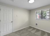 Thumbnail 6 of 30 - Living Room with a white door and a window at Swiss Gables Apartment Homes, Kent, Washington 98032