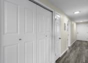 Thumbnail 30 of 30 - a long hallway with white closet doors and white walls at Swiss Gables Apartment Homes, Kent, WA