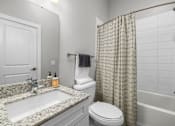 Thumbnail 66 of 75 - a bathroom with gray walls and a white sink and toilet  at Griffin Weston, Cary, North Carolina