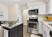 Thumbnail 7 of 31 - a kitchen with white cabinetry and stainless steel appliances  at Northridge, Rochester Hills