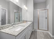 Thumbnail 63 of 75 - a bathroom with a large mirror and a shower with a glass door  at Griffin Weston, North Carolina