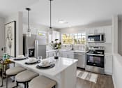 Thumbnail 1 of 24 - A modern kitchen with a breakfast table set for two at Briarcliff Village, Michigan, 48390