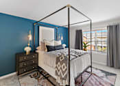 Thumbnail 10 of 24 - A bedroom with a four poster bed and a dresser at Briarcliff Village, Michigan, 48390