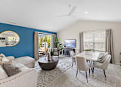 Thumbnail 8 of 24 - A living room with a blue wall and a television at Briarcliff Village, Michigan, 48390