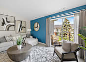Thumbnail 5 of 24 - A living room with a white couch, a coffee table, and a large window with a view of a house and trees outside at Briarcliff Village, Michigan, 48390