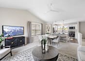 Thumbnail 9 of 24 - A living room with a television, a dining table, and chairs at Briarcliff Village, Michigan, 48390