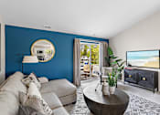 Thumbnail 6 of 24 - A living room with a grey couch and a round coffee table at Briarcliff Village, Michigan, 48390