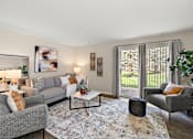 Thumbnail 17 of 24 - A living room with a grey couch, a grey armchair, a coffee table, and a rug at Briarcliff Village, Michigan, 48390