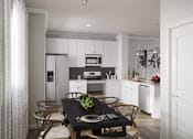 Thumbnail 49 of 75 - Townhome kitchen with stainless steel appliances, dining area, and granite countertops  at Griffin Weston, Cary