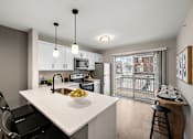 Thumbnail 6 of 26 - A modern kitchen with a white island and black chairs.