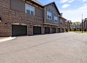 Thumbnail 72 of 75 - a driveway with a two car garage in front of a brick building  at Griffin Weston, Cary, North Carolina