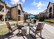 Thumbnail 42 of 75 - Patio with seating and fire pit at Griffin Weston apartments in Wake County, NC.