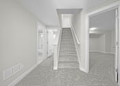 Thumbnail 16 of 22 - A hallway with a staircase leading to the second floor at Amberly Apartments, West Bloomfield, 48322