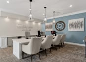 Thumbnail 30 of 34 - A conference room with a long table and chairs at Cidermill Village Apartments in Rochester Hills, MI 