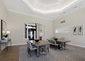 Thumbnail 29 of 34 - a dining room with a wooden table and chairs at Cidermill Village Apartments in Rochester Hills, MI 