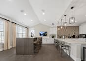 Thumbnail 24 of 34 - A modern kitchen with a wooden island and stainless steel appliances at Cidermill Village Apartments in Rochester Hills, MI 