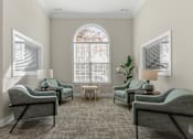 Thumbnail 21 of 34 - a living room with couches and chairs and a window at Cidermill Village Apartments in Rochester Hills, MI 