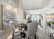 Thumbnail 15 of 26 - A dining room with a wooden table and chairs.