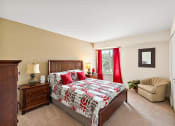 Thumbnail 30 of 31 - a bedroom with a bed and a chair  at Northridge, Michigan