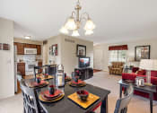 Thumbnail 12 of 31 - a dining area with a table and chairs and a living room in the background  at Northridge, Rochester Hills, Michigan