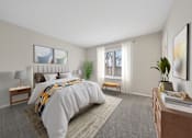 Thumbnail 4 of 17 - A bedroom with a large bed, a nightstand, a desk, and a window with a view of trees outside.