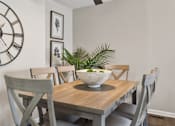 Thumbnail 7 of 16 - A dining room with a wooden table and chairs.
