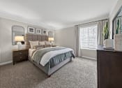 Thumbnail 8 of 16 - A bedroom with a large bed and a mirror on the wall.