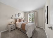 Thumbnail 10 of 16 - A bedroom with a bed, nightstand, and two lamps.